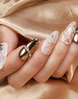 BEYONDCANVA Winter Elegance nail set featuring a pearl necklace design, sparkling snowflake accents, and an elegant bow, combining festive charm with sophisticated style—perfect for any winter gathering.