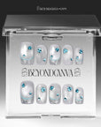 Clear BeyondCanva box displaying silver-white press-on nails with blue rhinestones and glitter tips.
