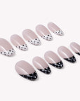 Bare Polka press-on nail set in nude pink with black and white polka dot tips arranged on a white background