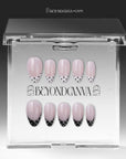 Bare Polka press-on nails in nude pink with black polka dot tips displayed in a clear packaging box