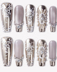 Baroque Crown press-on nails with silver chrome accents, white baroque scrollwork, pearl details, and rhinestone crown embellishments