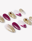 Flat lay of Berry Firelight press-on nails with burgundy, blush pink, gold glitter, and gemstone embellishments