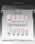 Packaging display of Boo Cuties press-on nails with pale pink bases, white ghost tips, black eyes, and pink cheeks in a clear BeyondCanva case