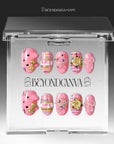 Bubblegum Pop Arcade handmade press-on nails displayed in clear packaging with a pink, plaid, gold, and gem-accented design.