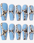 Denim Luxe press-on nails with sky blue bases, gold and black leopard accents, pearl chains, and rhinestone details