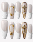 Divine Grace press-on nails with white sculpted bases, nude pearl shimmer, gold chrome accents, bead details, and rhinestone cross charms