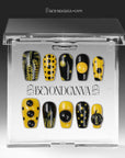 Dot Obsession press-on nails in black and yellow with bold polka dots displayed in a clear packaging box