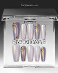 Emerald Venom press-on nails displayed in a clear packaging box