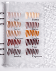 Fall Essence press-on nail color palette in a swatch book showing Pearl, Butter, Latte, Cocoa, Chestnut, Amber, Rose, Vino, Smoke, and Espresso shades
