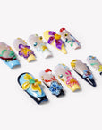 Angled flat lay of Floral Symphony press-on nails with 3D flowers, mushroom charms, rhinestones, and pastel tips