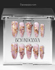 Gilded Petal Waltz press-on nails displayed in clear packaging with soft lavender, gold, pearls, and rhinestone floral accents