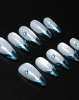 Silver and blue chrome press-on nails arranged in a flat lay