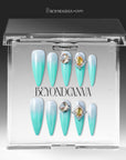 Glacier Jewel press-on nails displayed in a clear BeyondCanva case with icy blue ombré and yellow crystal embellishments