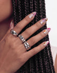 Close-up of a hand wearing pink floral cat-eye press-on nails