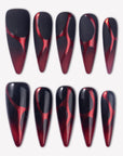 Inferno Veins press-on nails with black and deep red gradient stiletto tips, glossy and matte finishes, and red vein-like designs