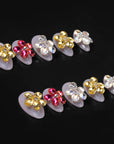 Two rows of jeweled floral press-on nail tips arranged on a black background.