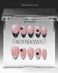 Packaging display of Ladybug Garden press-on nails with pink bases, black and white polka dot French tips, red ladybugs, and white flower charms in a clear BeyondCanva case