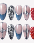 Liquid Mercury press-on nails with blue gray tips, nude pink bases, silver chrome swirls, and glossy red textured accents