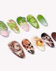 Matcha & Boba handmade press on nails arranged in a white flat lay with green and brown swirled nail designs