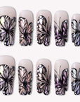 Midnight Monarch irregular shaped handmade press-on nails with black butterfly wing designs and iridescent shimmer