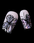 Midnight Monarch irregular shaped handmade press-on nails close-up with black butterfly wing designs and iridescent shimmer