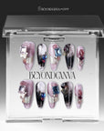Mineral Dreamscape press-on nails displayed in a clear BeyondCanva case with lilac, black, silver, and gemstone accents