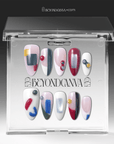 Packaging display of Modernist Dream press-on nails in a clear Beyondcanva case with abstract red blue yellow gray color blocks and raised round accents