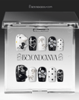 Packaging display of Monochrome Meow press-on nails in a clear BeyondCanva case with black and white cat designs, silver bows, pearl charms, and polka dots