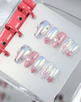 9 to 9 Chic pink and blue iridescent press-on nails with bows, pearls and stars displayed in a binder