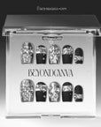 Noir Eclat press-on nails displayed in clear packaging with black bases, silver metallic accents, and pearl details