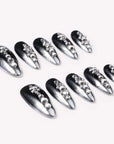 Obsidian Stardust handmade press-on nails flat lay showing black and silver gradient nails with rhinestone accents