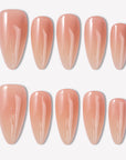 Peachy Juicy nude almond press-on nails with a glossy finish arranged in a white background flat lay