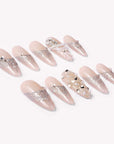 Pearl Cascade press-on nails in nude and silver with pearl and crystal accents arranged in a flat lay on a white background