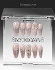 Pearl Cascade press-on nails in nude and silver with pearl and crystal accents displayed in a clear packaging box