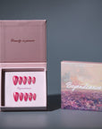 Open packaging box showing hot pink press-on nails with a separate branded card.