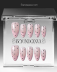 Packaging display of blush pink polka dot press-on nails in a clear BeyondCanva case.