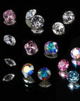 Assortment of premium cubic zirconia crystals in multiple cuts and colors on a black background