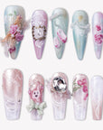 Rococo Reverie press-on nails with pastel blue and pink bases, 3D roses, pearls, lace details, bows, and rhinestone accents