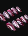 Rose Drift burgundy and pink cat eye almond press-on nail set arranged on a dark background with glossy wave details