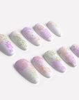 Secret Garden press-on nails arranged in a diagonal flat lay on a white background