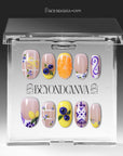 Clear packaging box displaying South Holiday press on nails with colorful floral and fruit-inspired designs