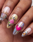 Close-up of stained glass press on nails with colorful heart and floral accent details