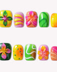 Tropical Jelly Bloom press-on nails in bright yellow, pink, green, and orange floral designs on a white background