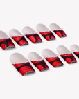 Flat lay of Vintage Ruby press-on nail swatches with red marbled bases and pearl accents
