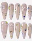 Water Drop Shimmer press-on nails with nude almond bases, pearl clusters, colorful gem accents, and tiny gold bead details