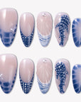 Whale Song press-on nails with blue ocean wave tips, whale tail design, white dot accents, seashell texture, pearl details, and glossy nude bases