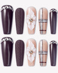 Winter Serenade press-on nails with deep purple tips, nude plaid accents, white 3D flowers, and rhinestone details