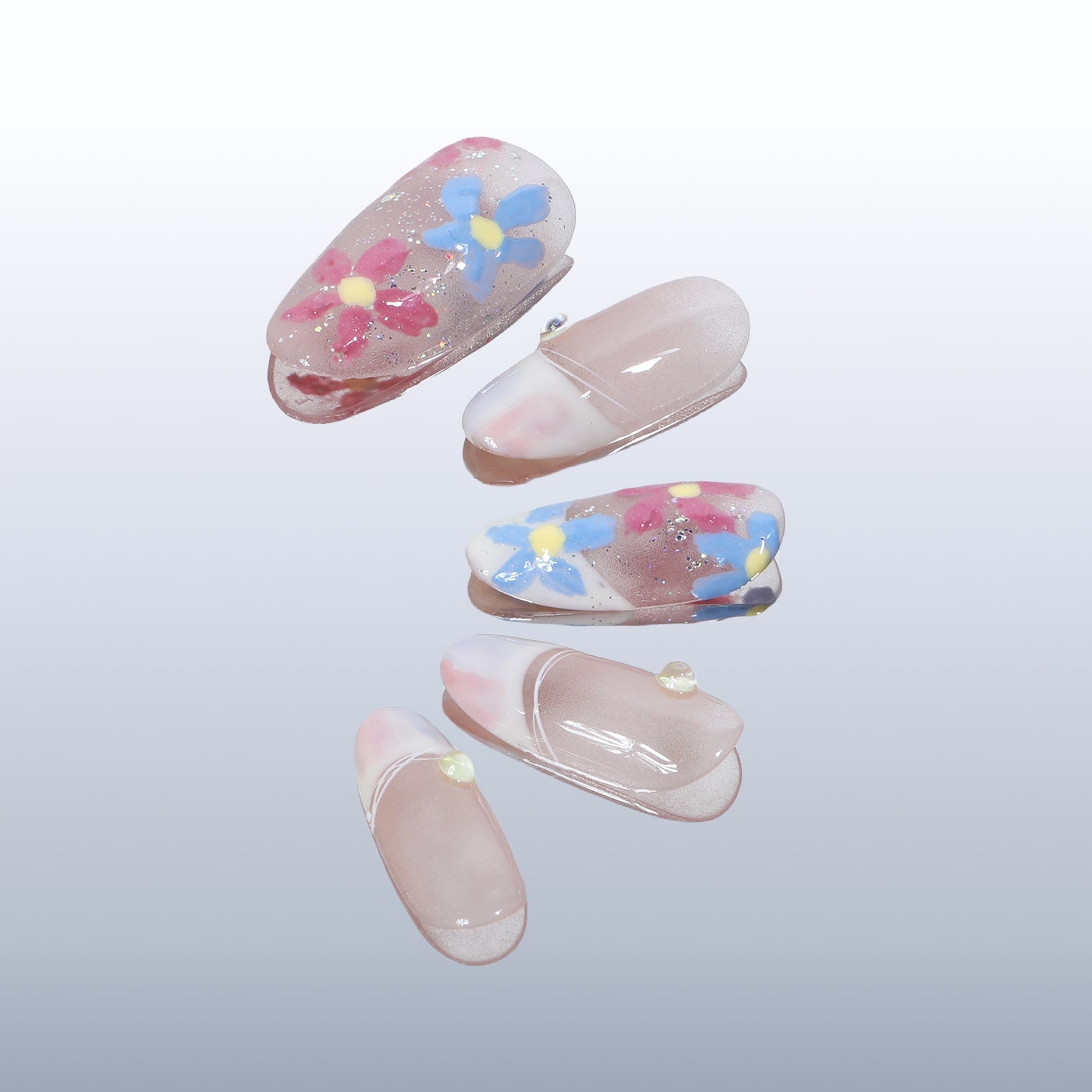 Beyondcanva press-on nails featuring colorful floral accents on a soft pink base, ideal for a chic and feminine style.