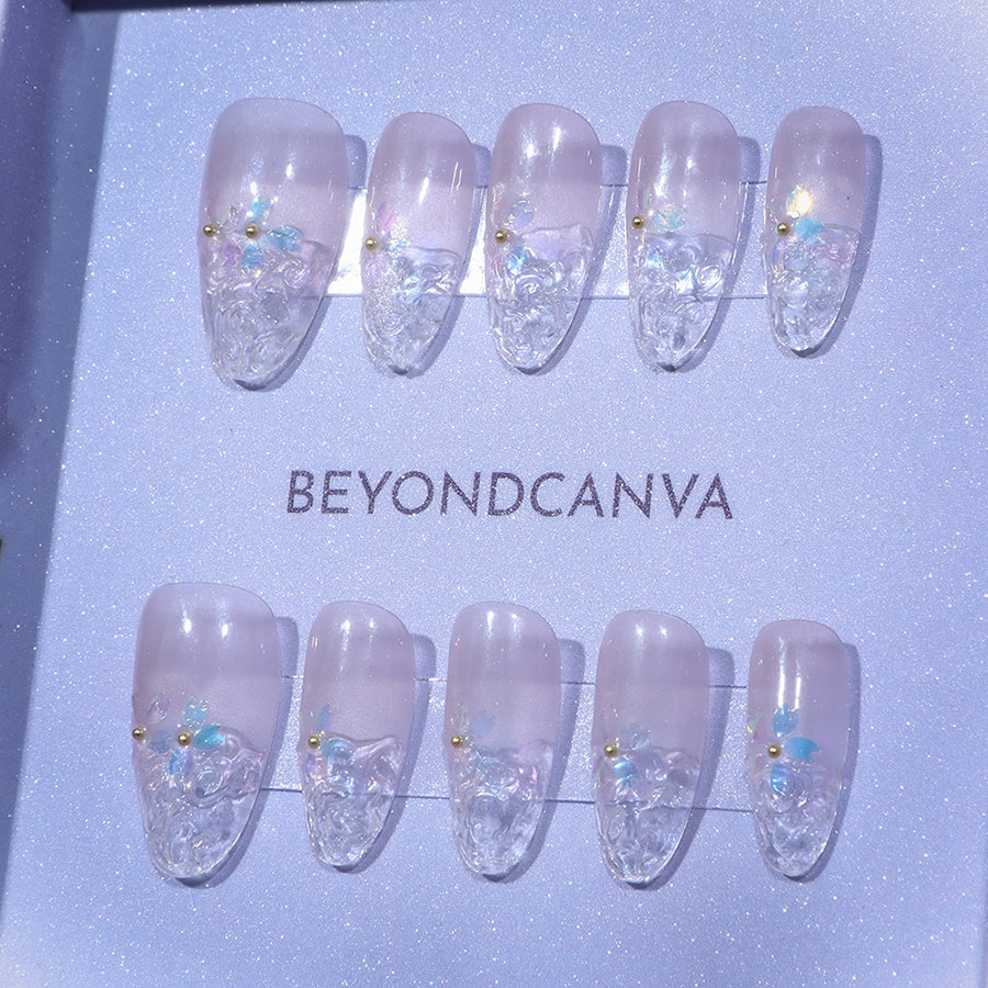 BEYONDCANVA press-on nails set with a soft pink base, clear textured tips, and floral embellishments in pastel hues, elegantly boxed.