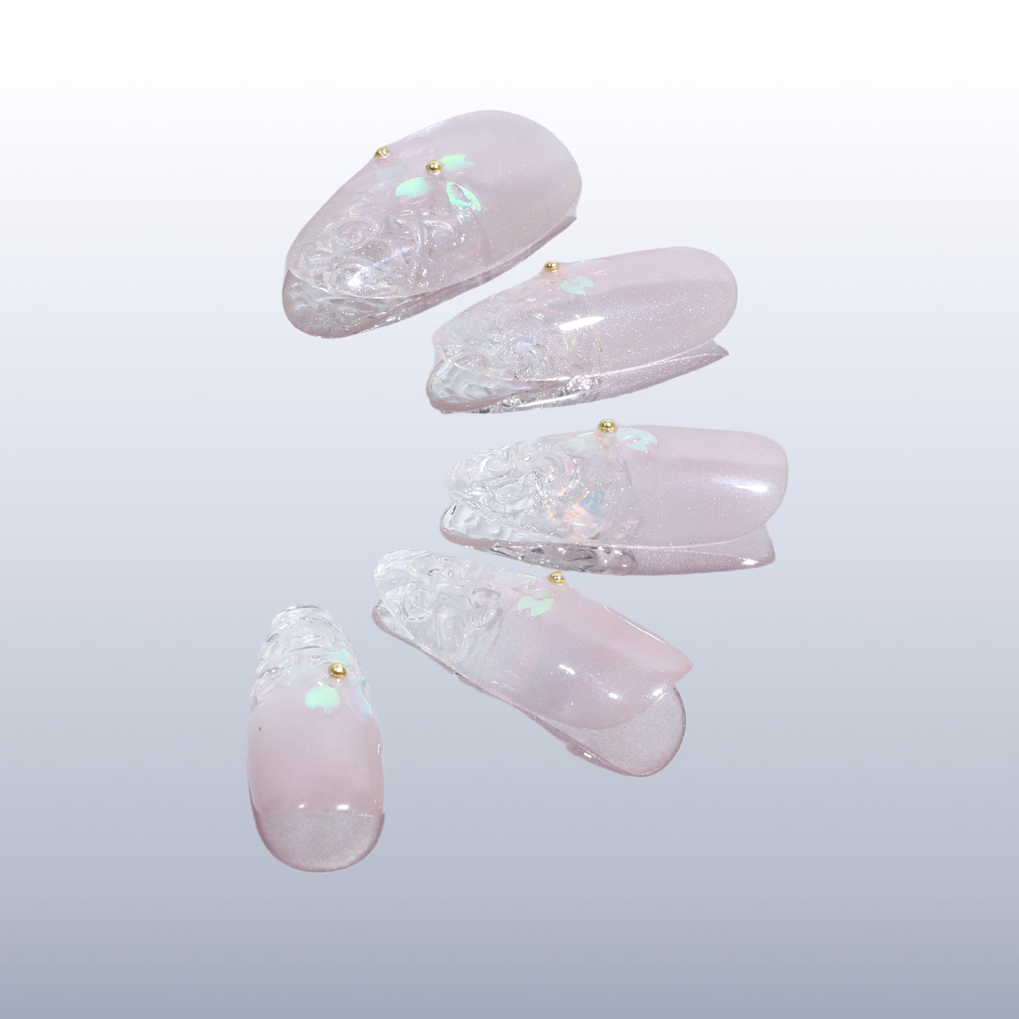 BEYONDCANVA press-on nails set with a soft pink base, clear textured tips, and floral embellishments in pastel hues, elegantly boxed.